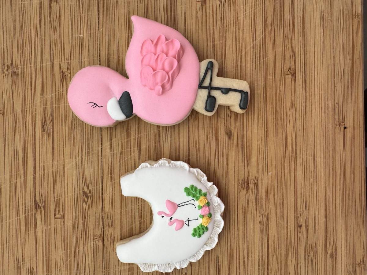 Pink flamingo decorated sugar cookies, including a scalloped design with a flamingo family and a large standing flamingo cookie